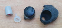 The Here One earbud, mold, adapter, and foam tip laid out apart.